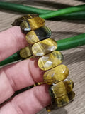 Geel tijgeroog, brede armband met grote ovale gefacetteerde kralen van 20/11 mm, prachtig