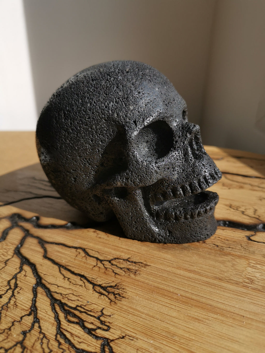 Zang-/lachende schedel van lavasteen · Natuurstenen sculptuur